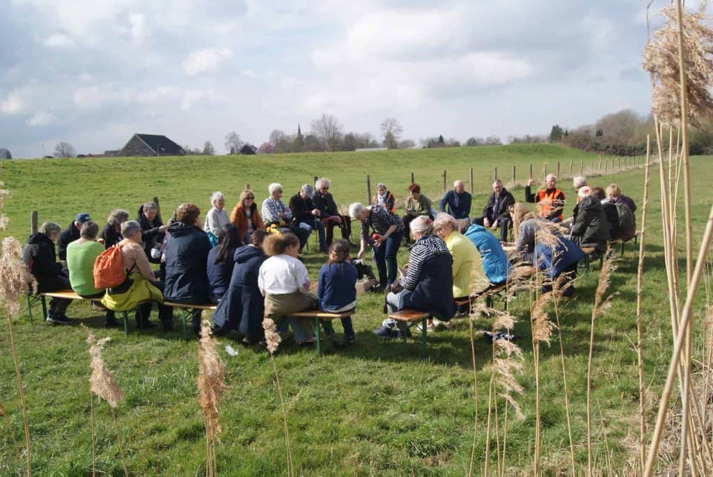 Gezamenlijke bijeenkomst op 't Gelders Eiland met mensen die in een cirkel zitten.