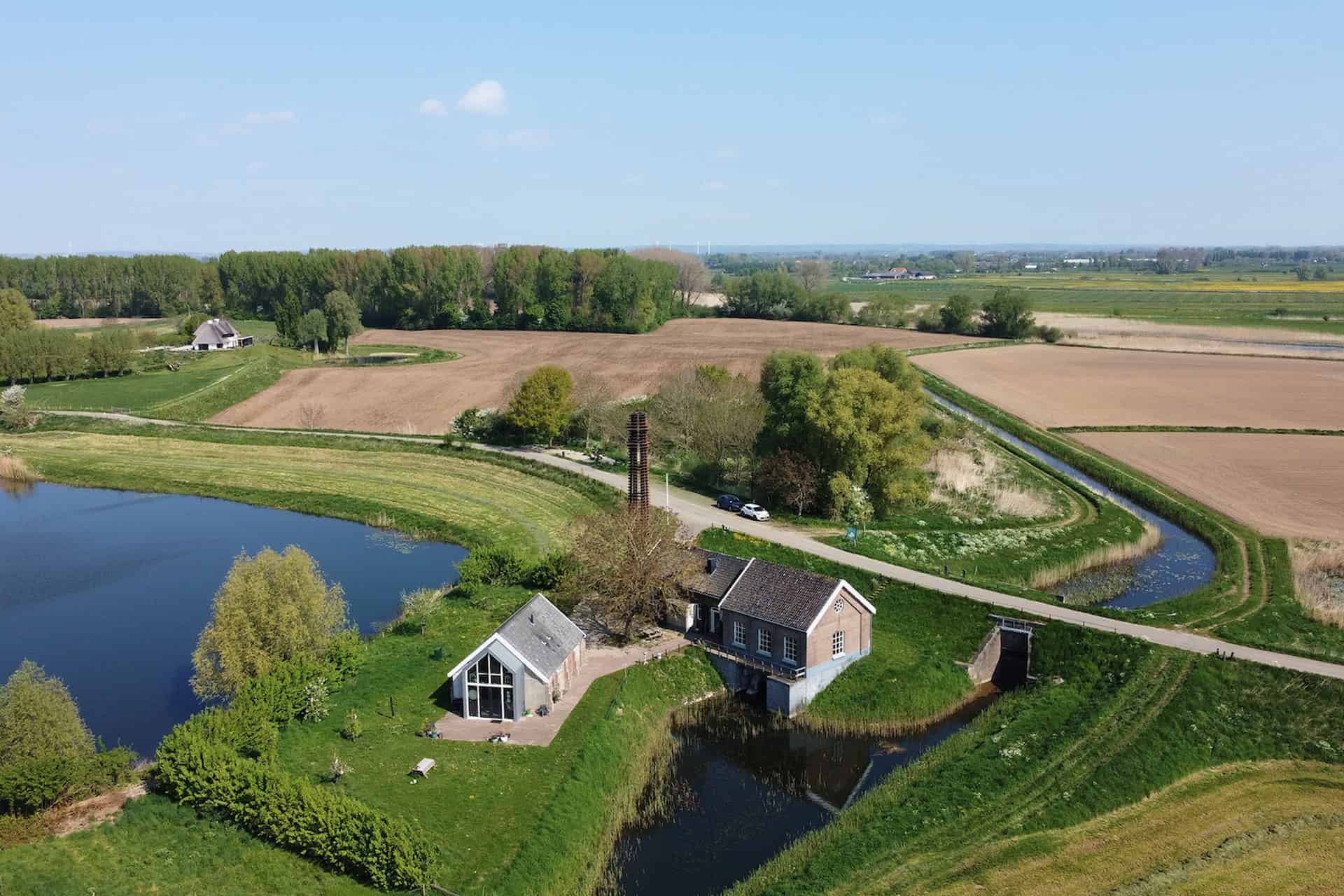 Uitzicht op landelijke boerderij en waterpartijen op 't Gelders Eiland.