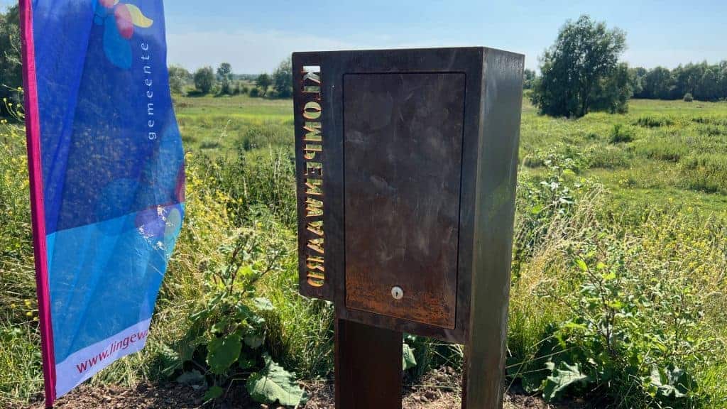 Informatiebord op 't Gelders Eiland met groene landschap op achtergrond.