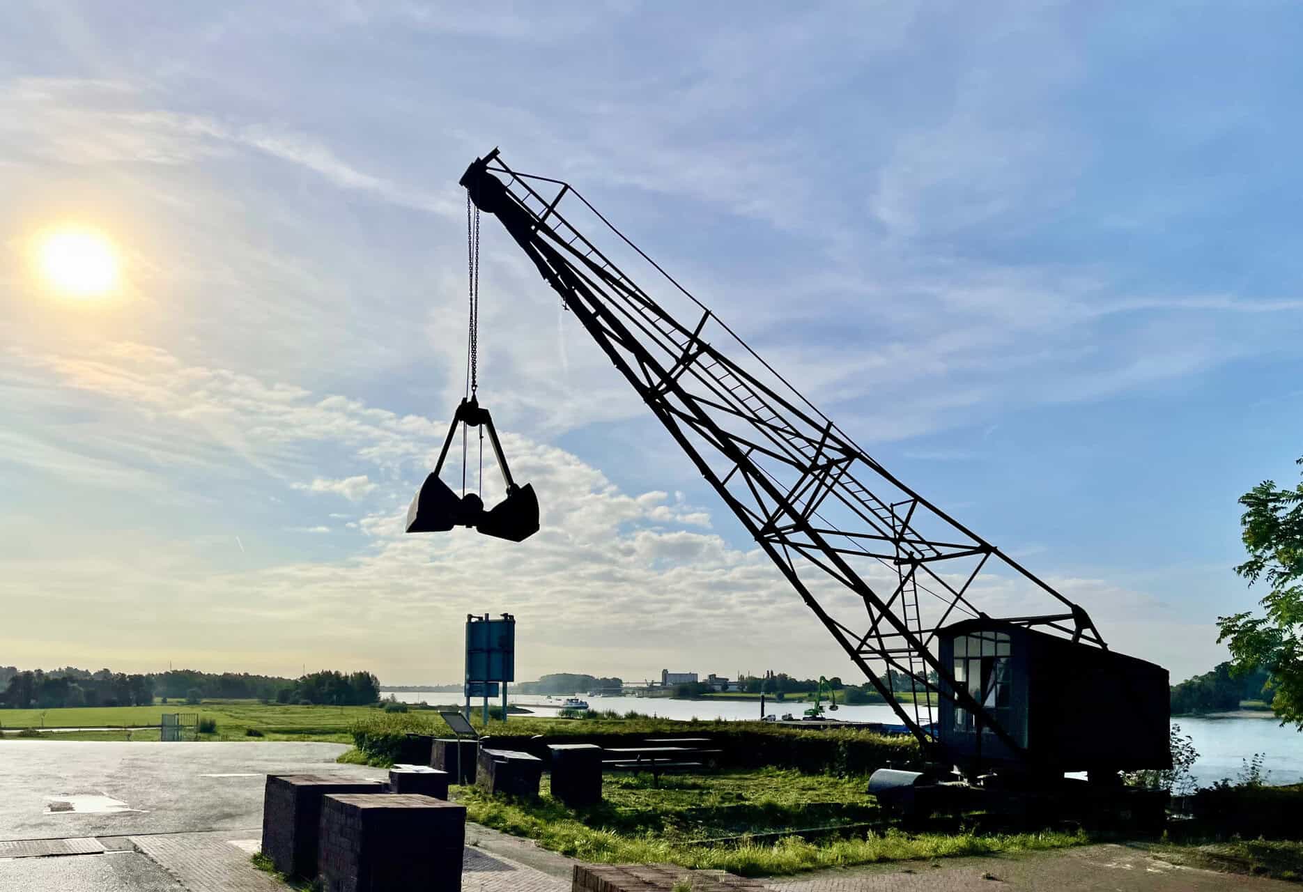 Kraan bij 't Gelders Eiland met uitzicht op rivier en groene omgeving.