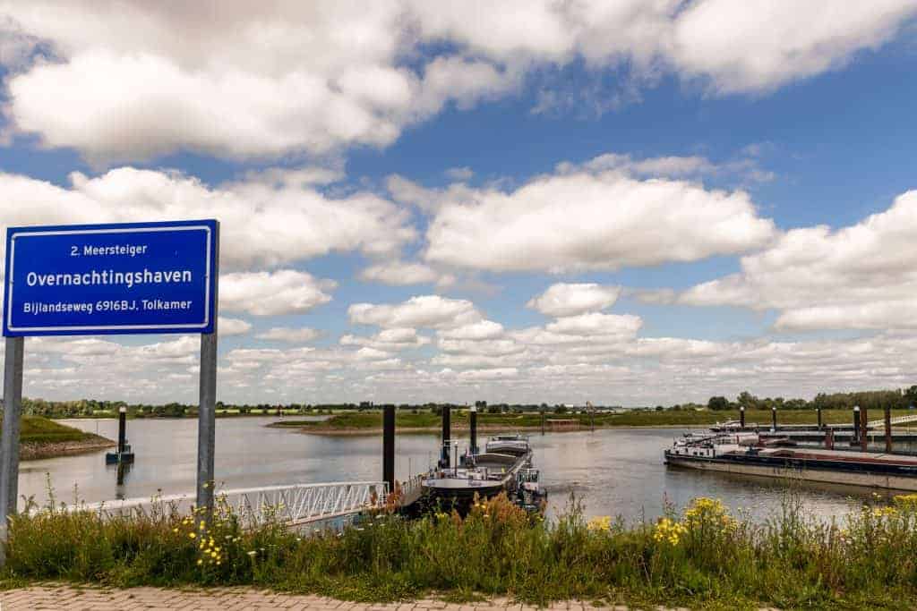 Overnachtingshaven op 't Gelders Eiland met boten en waterlandschap onder een partly cloudy sky.