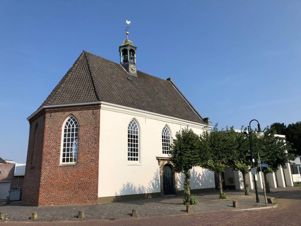 Historische kerk op 't Gelders Eiland met witte muren en grote ramen.